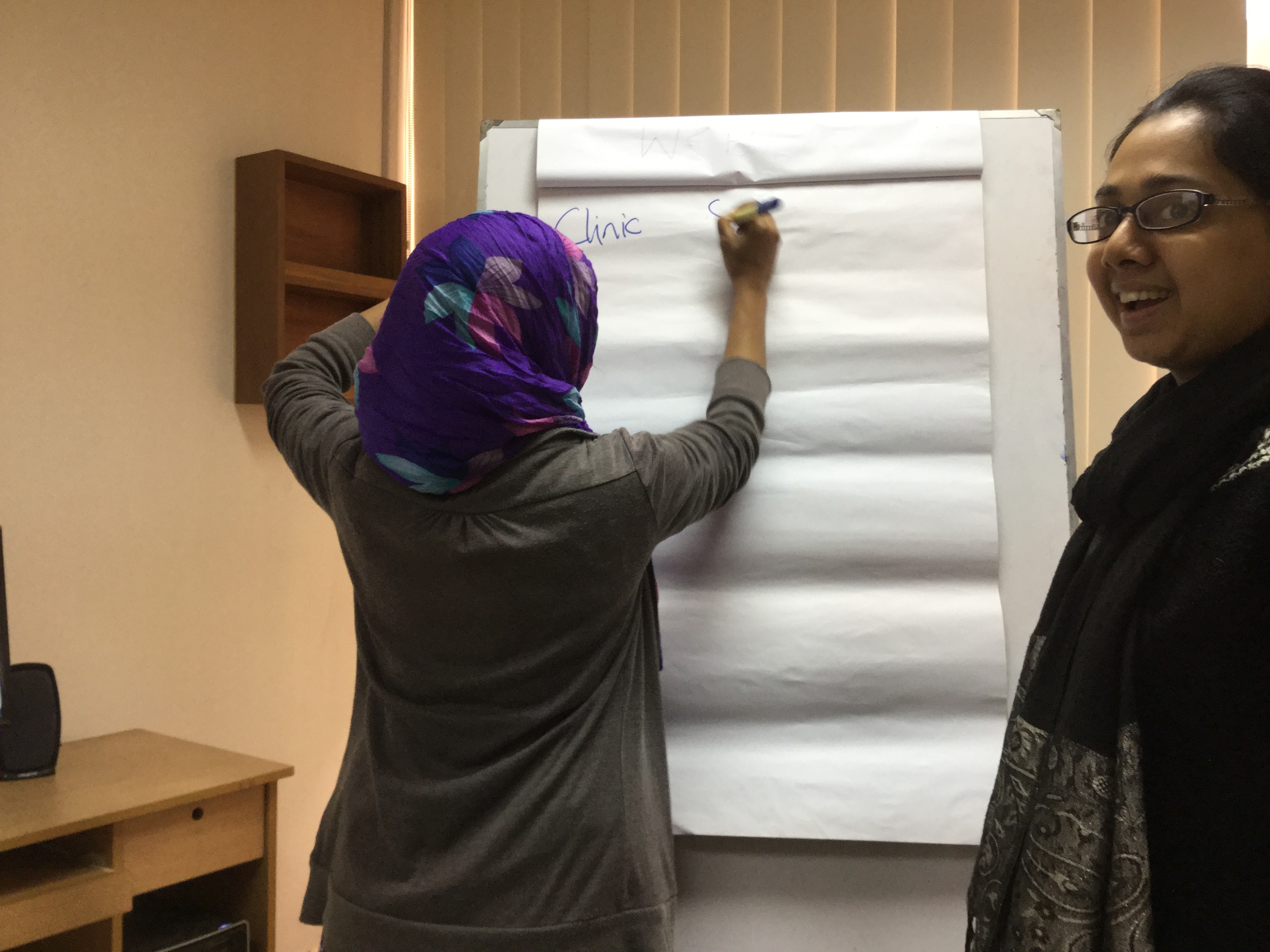 Woman writing on flip chart